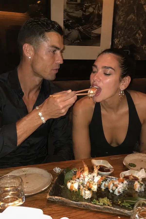 “Cristiano Ronaldo carefully feeding sushi to Dua Lipa like it’s the Champions League final.” 4K wallpaper for desktop and mobile - Pixbee