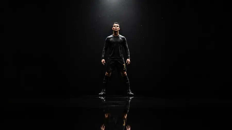 Cristiano Ronaldo Standing in Full Black Kit Under a Single Spotlight 4K wallpaper for desktop and mobile - Pixbee