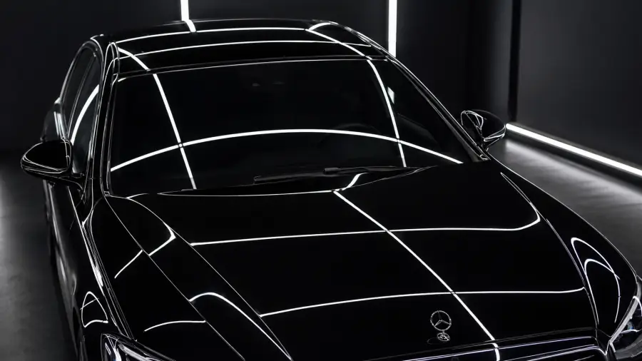 High Angle View of Crisp Overhead Studio Light Reflections on a Black Mercedes Benz Hood 4K wallpaper for desktop and mobile - Pixbee