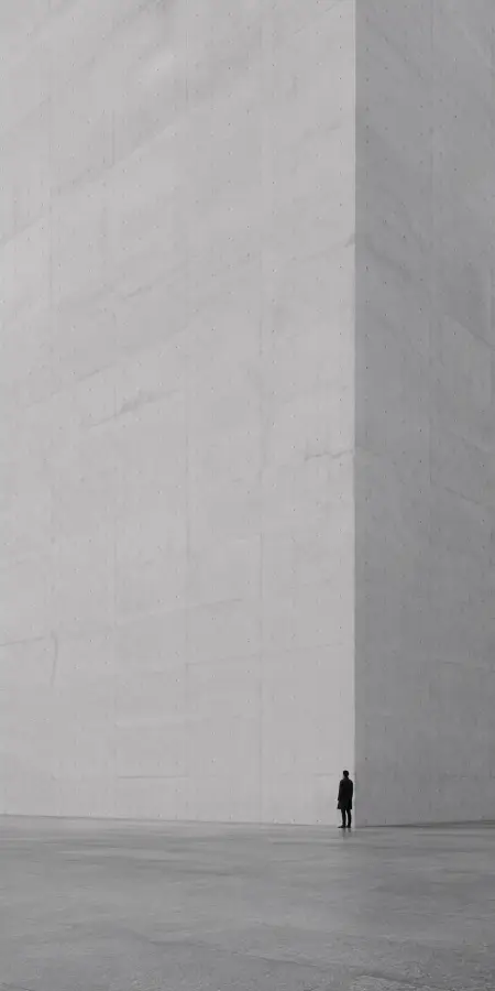 Lonely Man Standing Beside Massive Concrete Wall Minimalist 4K wallpaper for desktop and mobile - Pixbee