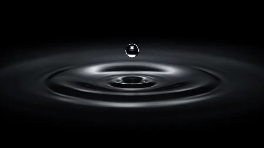 Macro Shot of a Single Water Droplet Suspended Above Concentric Ripples 4K wallpaper for desktop and mobile - Pixbee