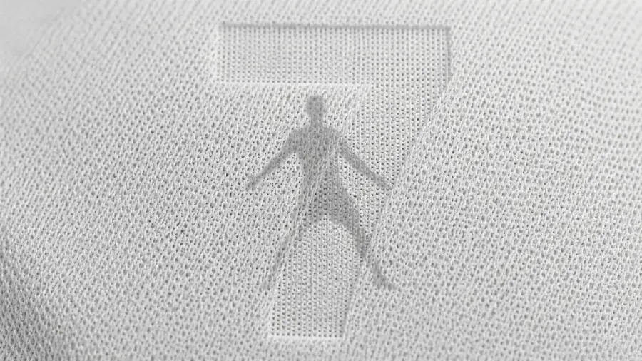 Macro Texture of White Knitted Fabric with an Embossed Silhouette of Cristiano Ronaldo and Number 7 4K wallpaper for desktop and mobile - Pixbee