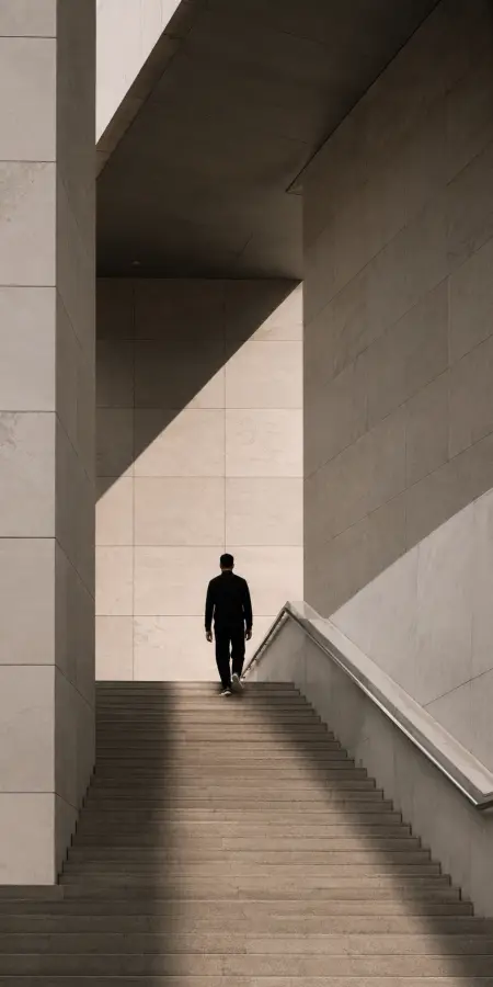 Man Walking Up Modern Geometric Stone Staircase 4K wallpaper for desktop and mobile - Pixbee