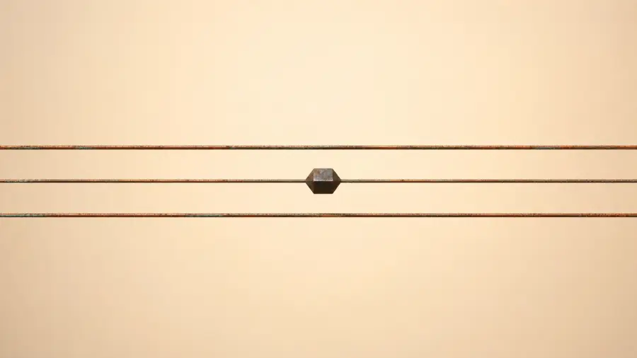 Minimalist Composition of Three Horizontal Copper Wires with a Centered Hexagonal Bead 4K wallpaper for desktop and mobile - Pixbee