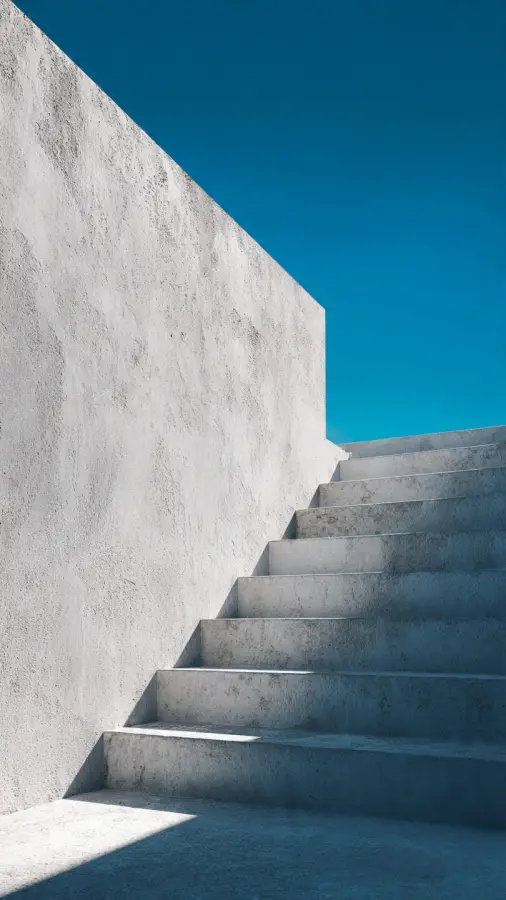 Minimalist Concrete Staircase with Clean Blue Sky Background 4K wallpaper for desktop and mobile - Pixbee