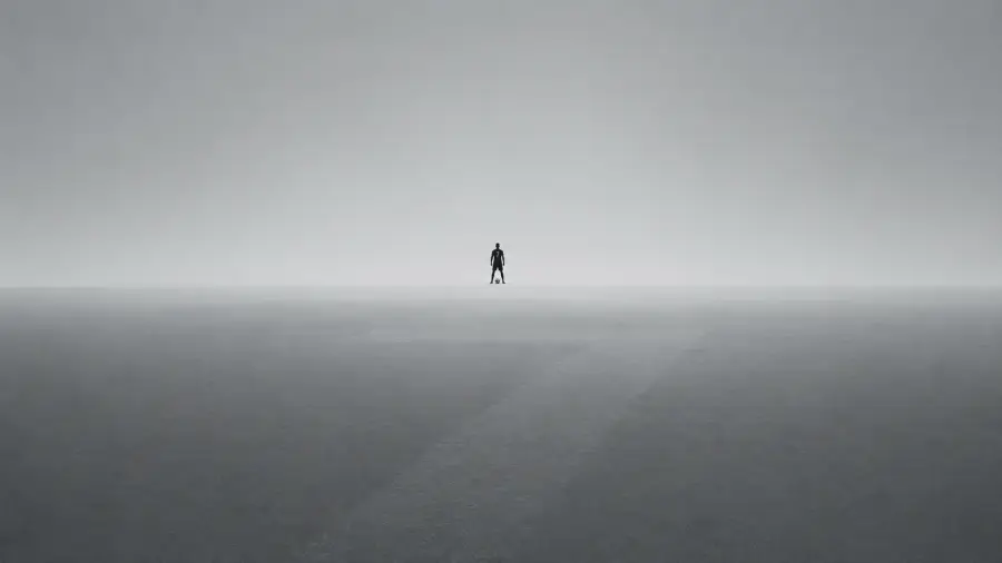 Minimalist Silhouette of Cristiano Ronaldo Standing Solo on a Vast Misty Grey Horizon 4K wallpaper for desktop and mobile - Pixbee