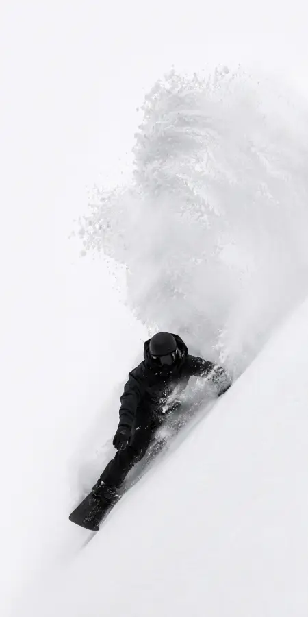 Snowboarder Carving Deep Through White Powder — ue5 phone wallpaper